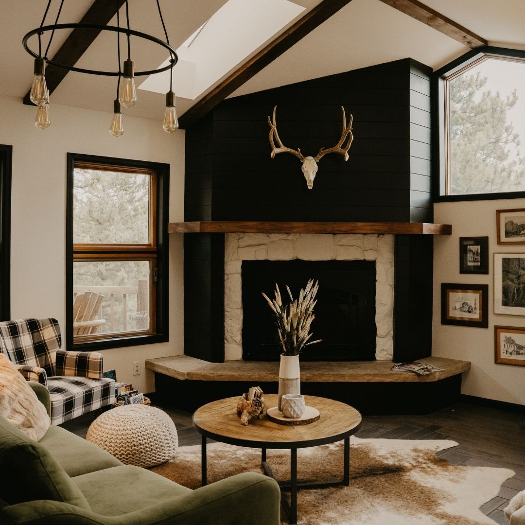 mountain cabin design with stone fireplace, plaid upholstery and natural wood accents